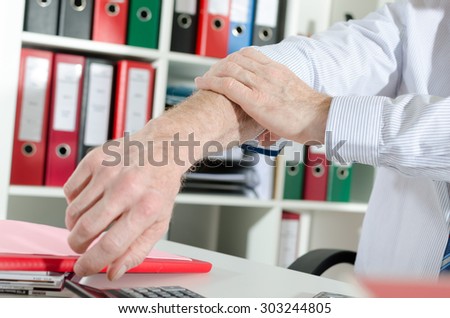 Businessman rolling up his sleeve at office