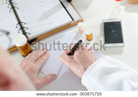 Doctor writing prescription at medical office