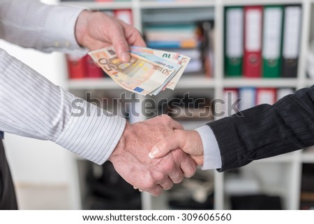 Hand shake deal with cash exchange
