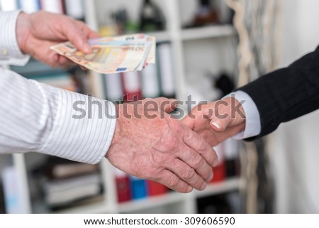 Hand shake deal with cash exchange