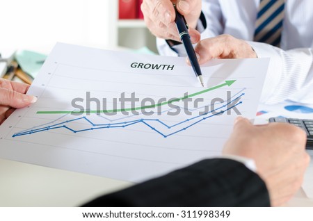 Business people in meeting analyzing financial results
