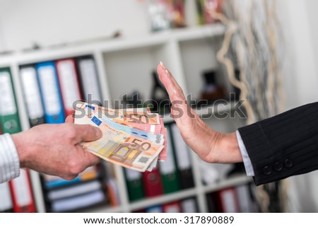Woman hand rejecting an offer of money