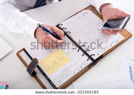 Businessman taking an appointment at office