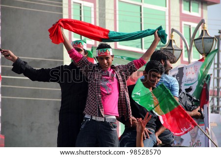 SIALKOT, PAKISTAN - MAR 23: PTI Supporter dancing while coming at Jinnah Cricket Stadium during a political rally of cricketer turned politician Imran Khan on March 23, 2012 in Sialkot, Pakistan
