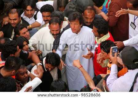 SIALKOT, PAKISTAN - MAR 23: Imran Khan entering the venue at Jinnah Cricket Stadium during a political rally on March 23, 2012 in Sialkot, Pakistan