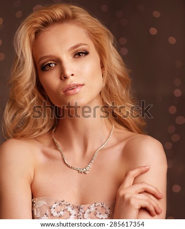 Luxury woman posing. Head shot on bokeh background