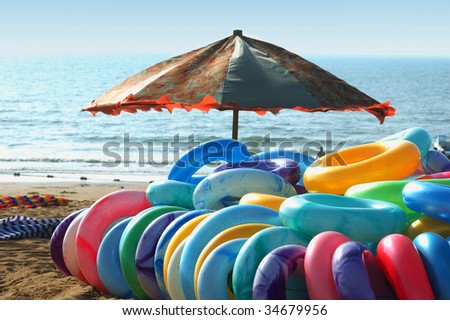 Swim rings and umbrella on the beach