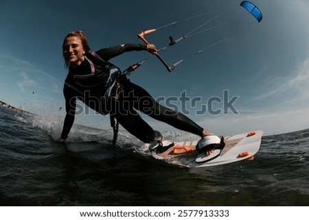 Similar – Image, Stock Photo Female athlete in wetsuit on calm lake shore