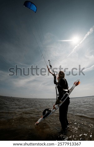 Similar – Image, Stock Photo Female athlete in wetsuit on calm lake shore