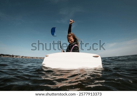 Similar – Image, Stock Photo Female athlete in wetsuit on calm lake shore