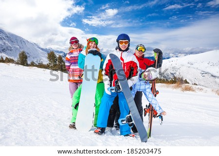 Funny friends with snowboards and skis