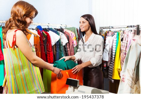 Woman with purchase after paying at cashiers desk