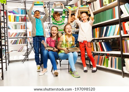 Excited happy laughing children in library