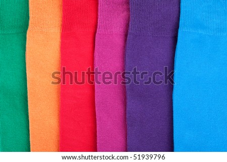 Different color textile fabrics clothes lay in row