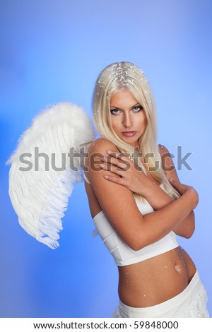 Blond woman angel with wings on blue background