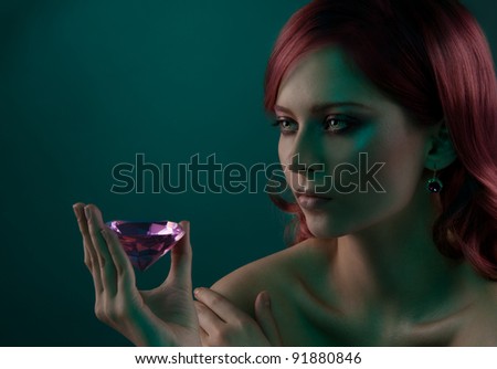Beauty portrait of woman with big pink diamond