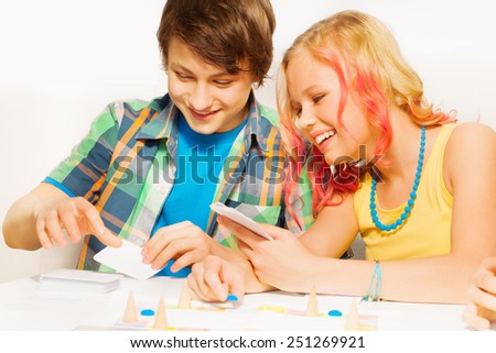 Boy and girl playing table game at home