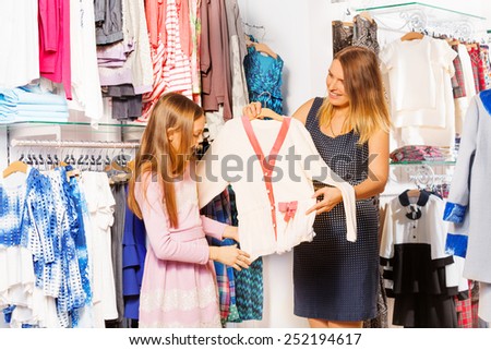 Girl and her mother shopping together in the store