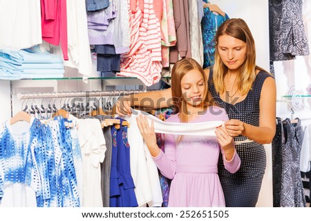 Smiling girl with her mother shopping together