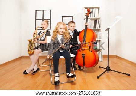 Happy kids playing musical instruments together