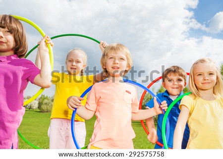Close-up of children holding hula hoops in park