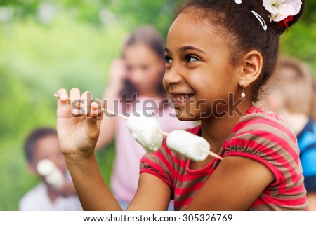 Portrait of African girl and marshmallow stick