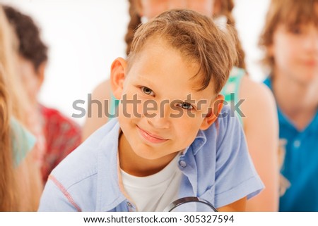Clever looking boy in the group of kids