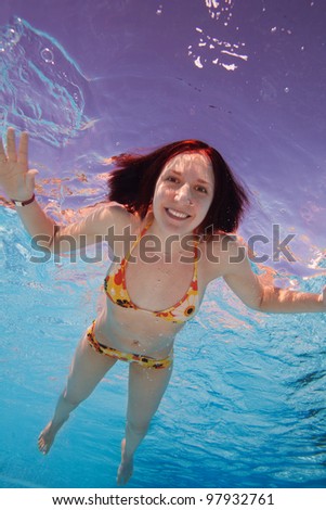 Really happy young woman swimmer - underwater shot
