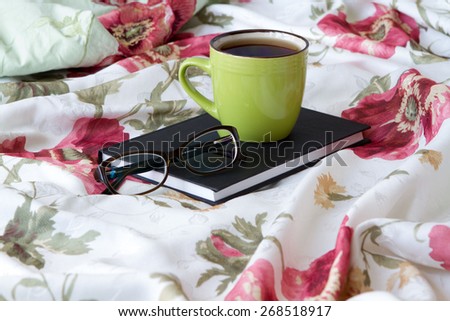 green cup of tea on the book bed bed reading glasses learn learning linen floral print