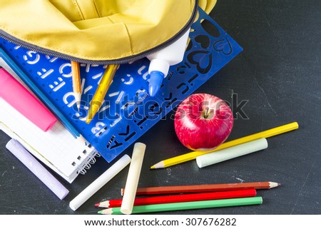 school student notebook accessories pens pencils on a black background board