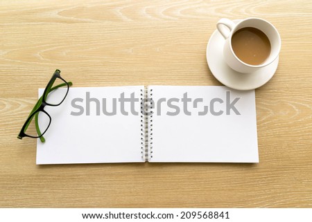 Time for creative. double blank paper with glasses and a cup of coffee on wood table