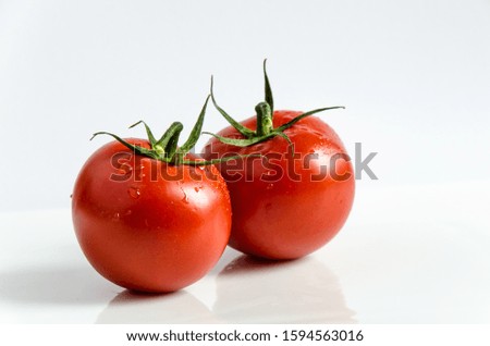 Similar – Image, Stock Photo Fresh panicles of tomatoes on a colourful plate