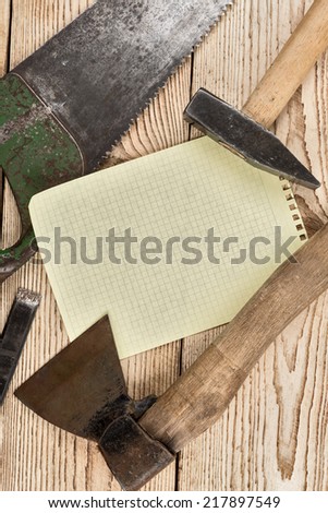 Woodworking tools, recording sheet and a wooden background