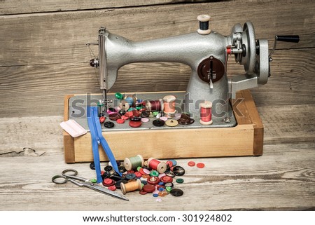 Retro sewing machine on a wooden background