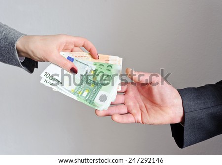 Female hand gives money, the man\'s hand takes them