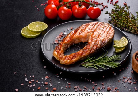 Fresh cooked delicious salmon steak with spices and herbs baked on a grill. Healthy seafood food Сток-фото © 