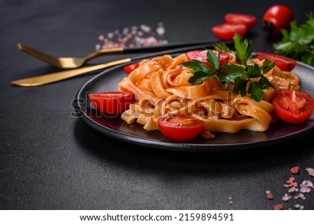 Similar – Image, Stock Photo Green tagliatelle pasta with ham, parmesan cheese, arugula and tomatoes on black plate