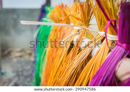 soft focus (depth on field)?many color of dry straw mats hanging on bamboo bar