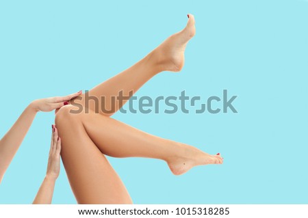 Beautiful long woman's legs with smooth skin after depilation on pastel blue background. Imagine de stoc © 