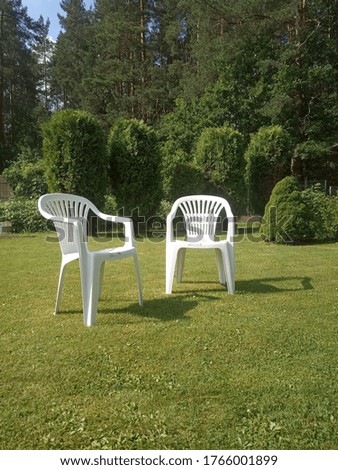 Similar – Image, Stock Photo White plastic garden bench stands on a meadow with yellow flowers