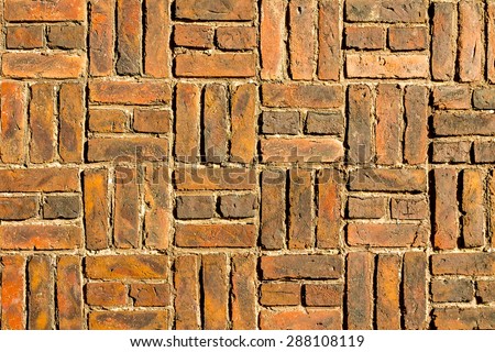 Red bricks laid to the wall in groups of three background