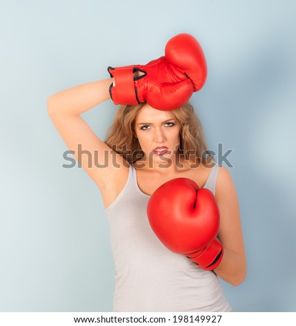 sexy woman looking tired wearing red boxing gloves
