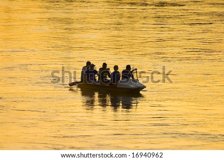 The picture of silhouette of people on boat