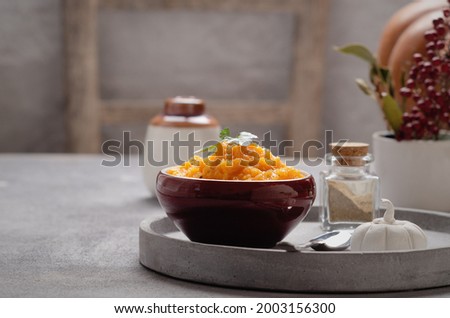 Pumpkin purea in a brown bowl on grey background. Foto d'archivio © 