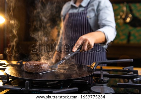 Similar – Image, Stock Photo Chef preparing burgers at grill plate on international urban street food festival.