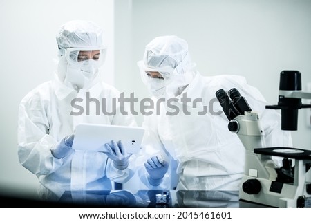 Similar – Image, Stock Photo Female doctor in coveralls holding COVID-19 PCR nasal swabbing kit