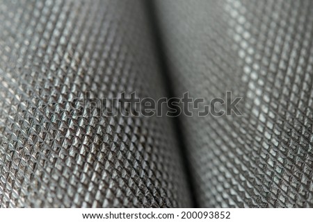Metal rod or leather texture closeup dumbbells