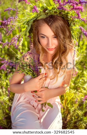 Fashionable toning, creative colors.  Beautiful girl in a white dress lies in the cloud.	 Beautiful girl in the a wreath made of shells. The spirit of the river walking through the swamp