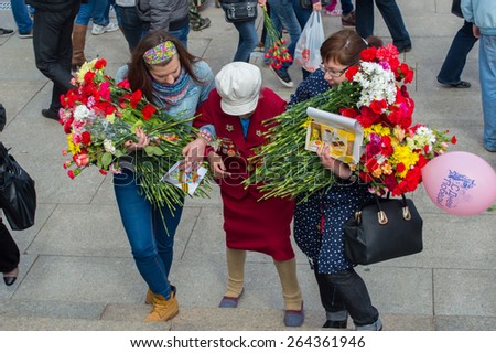 Russia, St. Petersburg - MAY 9: day of victory, memory of heroes. The memory of soldiers in Great Patriotic War ( World War II ). 2014.  Girls help a woman war veteran climb the stairs
