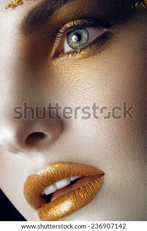 Close up portrait. Girl with golden makeup, beauty face, portrait women, art, black background.